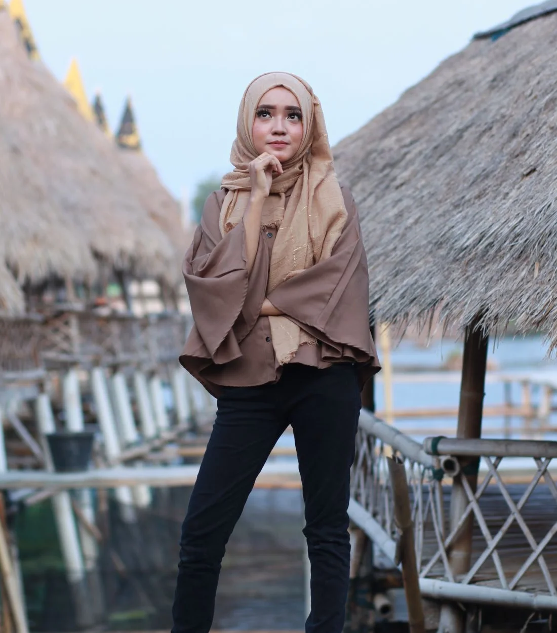 A woman wearing a draped beige scarf — illustrative styling photograph
